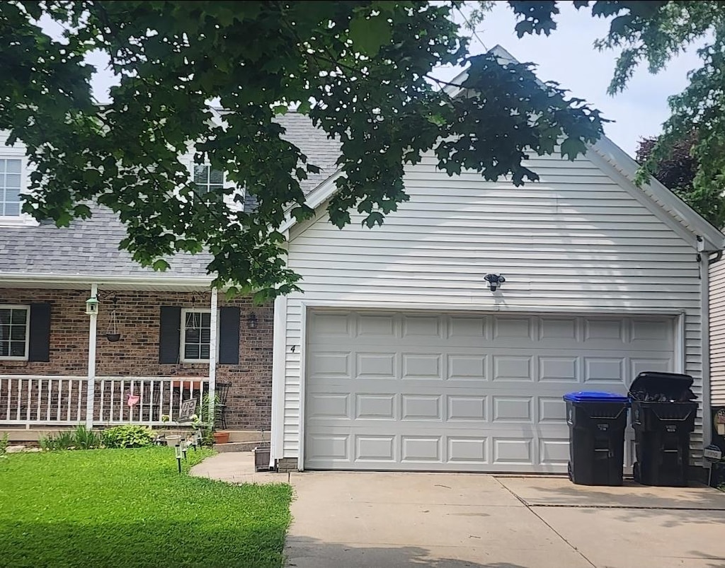 4 Rounds Rd, Bloomington, IL 61704 - view of front of home featuring concrete driveway, covered porch, and brick siding