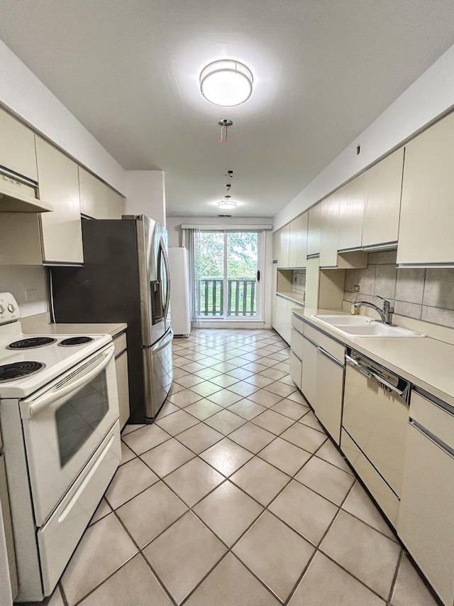 1125 Lake Cook Rd Unit 209, Northbrook, IL 60062 - kitchen featuring white appliances, light countertops, backsplash, light tile patterned floors, and range hood