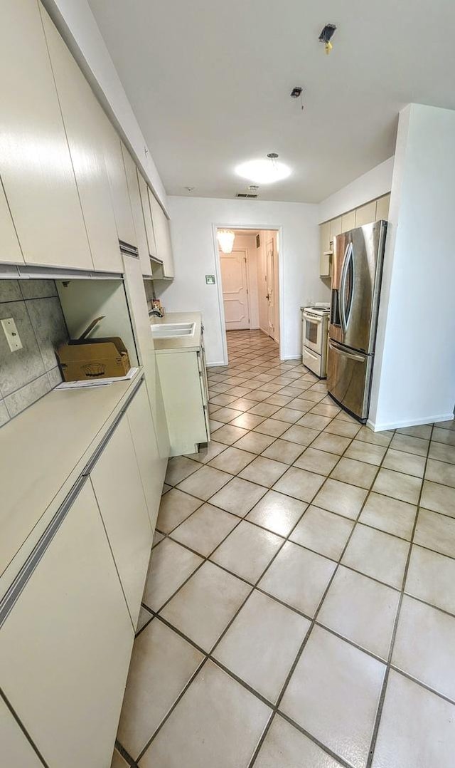1125 Lake Cook Rd Unit 209, Northbrook, IL 60062 - kitchen featuring stainless steel fridge, white range with electric cooktop, light countertops, light tile patterned flooring, and range