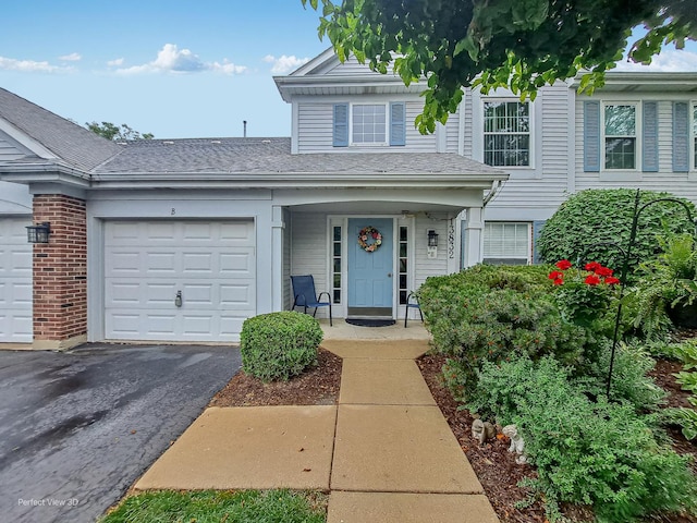 13832 S Balsam Ln Unit B, Plainfield, IL 60544 - view of front facade with driveway, a garage, and roof with shingles