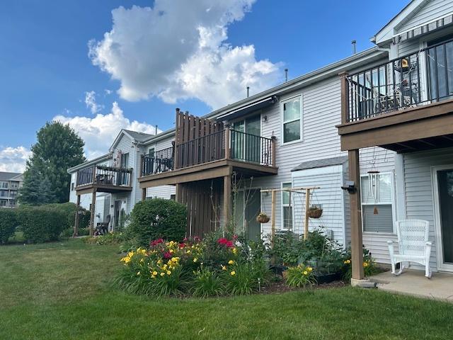 13832 S Balsam Ln Unit B, Plainfield, IL 60544 - rear view of property with a balcony and a yard