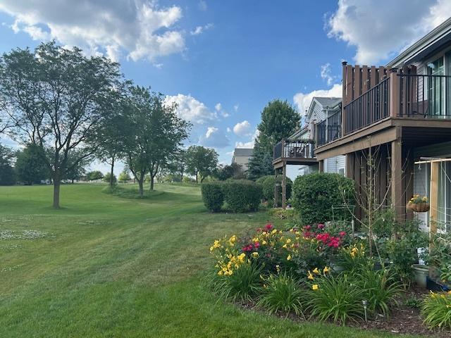 13832 S Balsam Ln Unit B, Plainfield, IL 60544 - view of grassy yard featuring a deck
