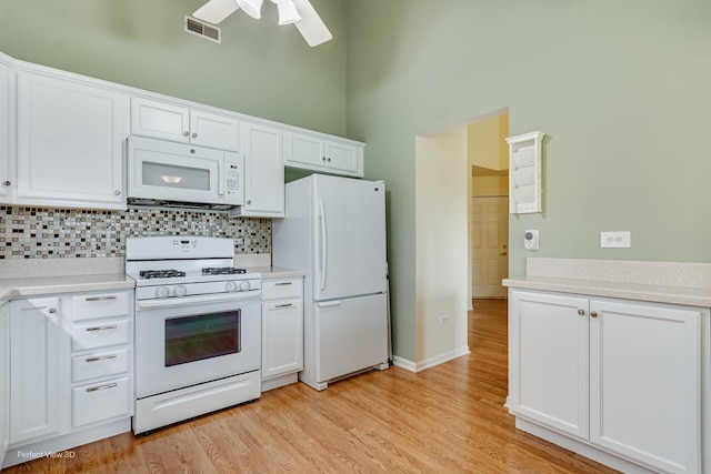 13832 S Balsam Ln Unit B, Plainfield, IL 60544 - kitchen with white appliances, tasteful backsplash, white cabinets, a ceiling fan, and light countertops