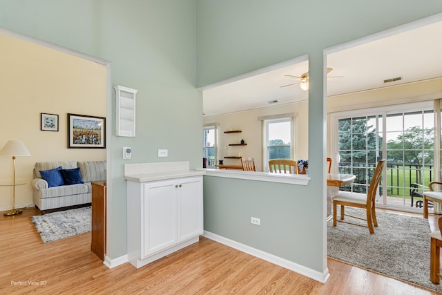 13832 S Balsam Ln Unit B, Plainfield, IL 60544 - kitchen featuring light wood-style floors, white cabinetry, ceiling fan, light countertops, and open floor plan