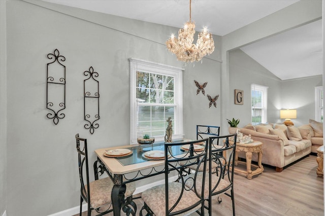 1825 Parkdale Dr, Champaign, IL 61821 - dining space featuring a chandelier, light wood finished floors, healthy amount of natural light, and lofted ceiling