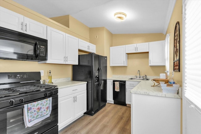 1825 Parkdale Dr, Champaign, IL 61821 - kitchen featuring black appliances, white cabinetry, and light wood-type flooring