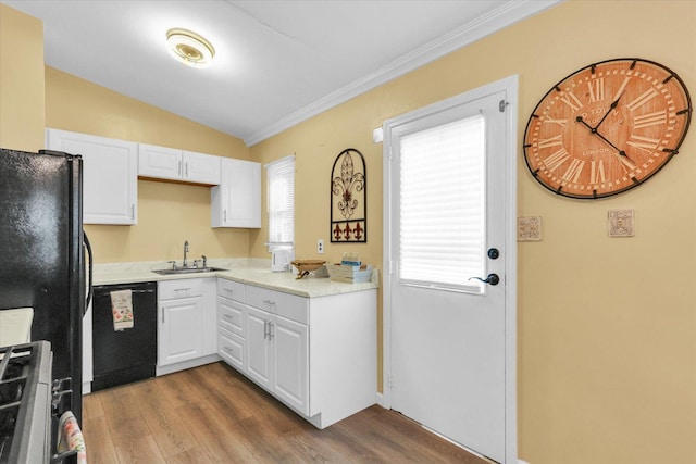 1825 Parkdale Dr, Champaign, IL 61821 - kitchen with black appliances, wood finished floors, white cabinetry, ornamental molding, and vaulted ceiling