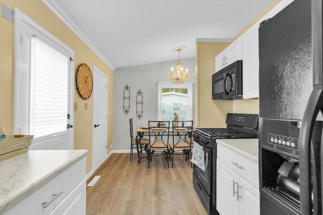 1825 Parkdale Dr, Champaign, IL 61821 - kitchen featuring black appliances, a chandelier, light wood-style flooring, lofted ceiling, and white cabinets