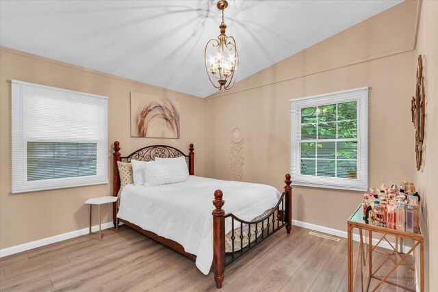 1825 Parkdale Dr, Champaign, IL 61821 - bedroom with a chandelier, light wood-type flooring, and vaulted ceiling