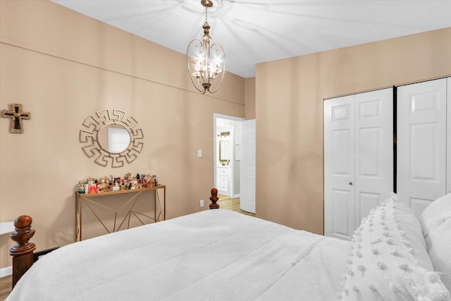 1825 Parkdale Dr, Champaign, IL 61821 - bedroom with a chandelier, a closet, and wood finished floors