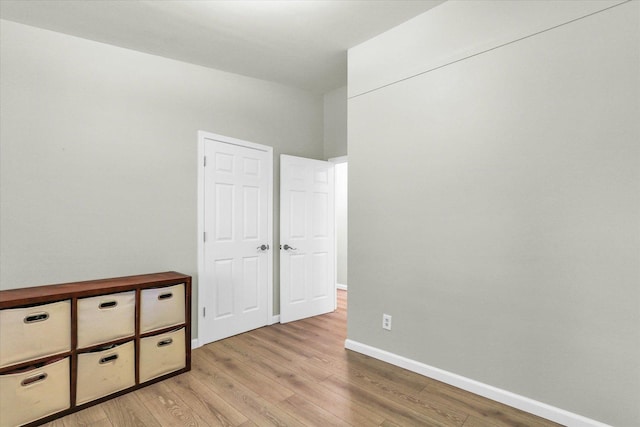 1825 Parkdale Dr, Champaign, IL 61821 - unfurnished bedroom with light wood-style flooring and baseboards