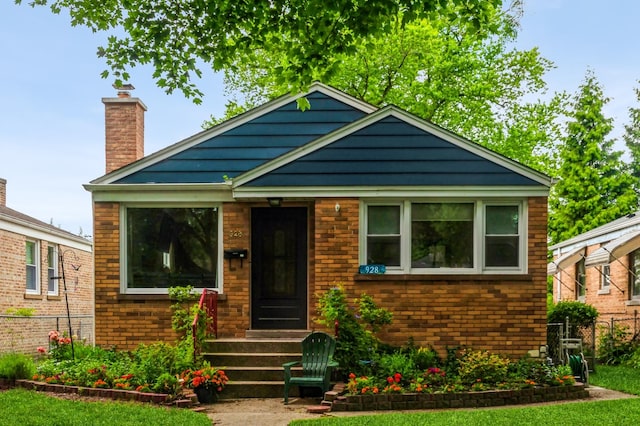 928 Grey Ave, Evanston, IL 60202 - bungalow-style house with a chimney and brick siding