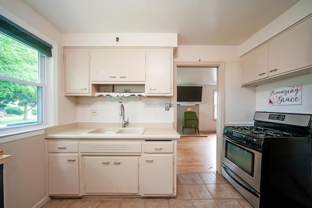 928 Grey Ave, Evanston, IL 60202 - kitchen with stainless steel range with gas stovetop, light countertops, backsplash, and open shelves