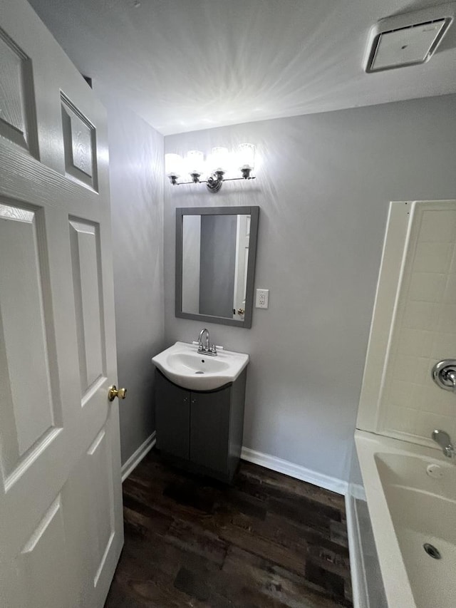 6643 S 13370e Rd, Pembroke Twp, IL 60958 - full bath with vanity, a tub to relax in, and wood finished floors