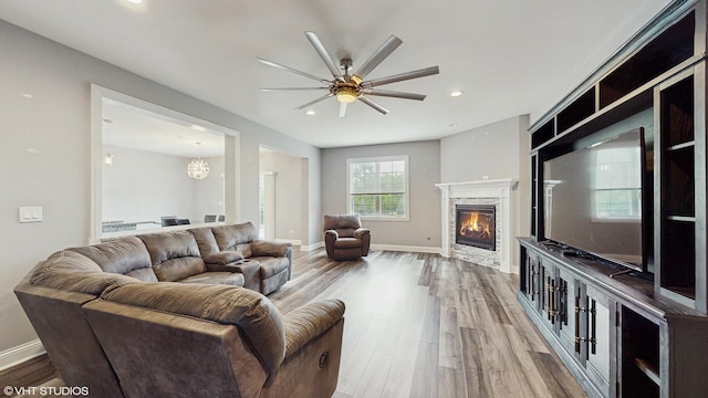 14948 S Preserve Dr, Lockport, IL 60441 - living area with wood finished floors, a ceiling fan, a fireplace, recessed lighting, and a chandelier