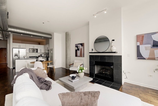 700 N Larrabee St Unit 2010, Chicago, IL 60654 - living area featuring dark wood-style flooring, a tiled fireplace, and track lighting
