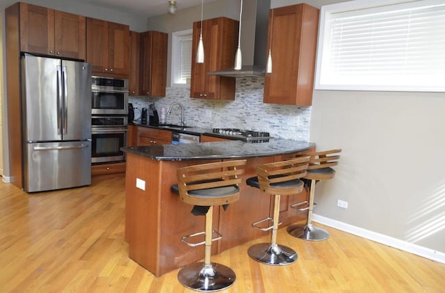 4435 S Oakenwald Ave Unit 1, Chicago, IL 60653 - kitchen with stainless steel appliances, wall chimney exhaust hood, light wood-type flooring, and decorative backsplash