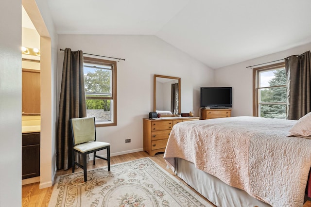 307 Valley Rd, North Aurora, IL 60542 - bedroom with multiple windows, lofted ceiling, light wood-type flooring, and ensuite bath