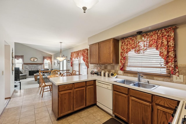 307 Valley Rd, North Aurora, IL 60542 - kitchen featuring white dishwasher, a peninsula, light countertops, plenty of natural light, and lofted ceiling