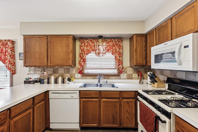 307 Valley Rd, North Aurora, IL 60542 - kitchen featuring white appliances, light countertops, backsplash, and brown cabinetry
