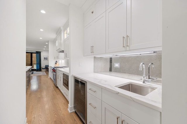 832 W Altgeld St Unit 1, Chicago, IL 60614 - kitchen with wine cooler, light wood-style floors, white cabinets, tasteful backsplash, and light stone countertops