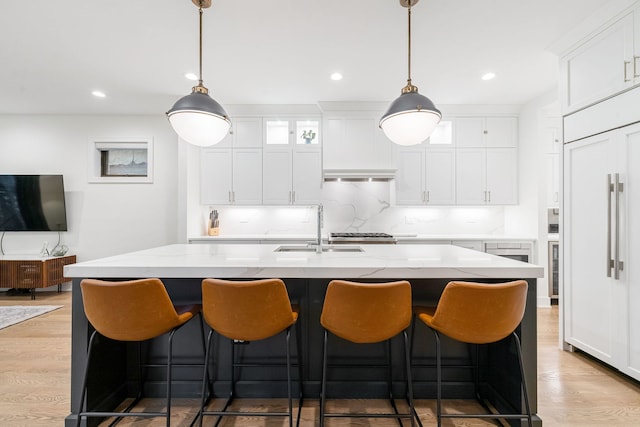 832 W Altgeld St Unit 1, Chicago, IL 60614 - kitchen with paneled fridge, white cabinets, light wood-type flooring, range hood, and recessed lighting
