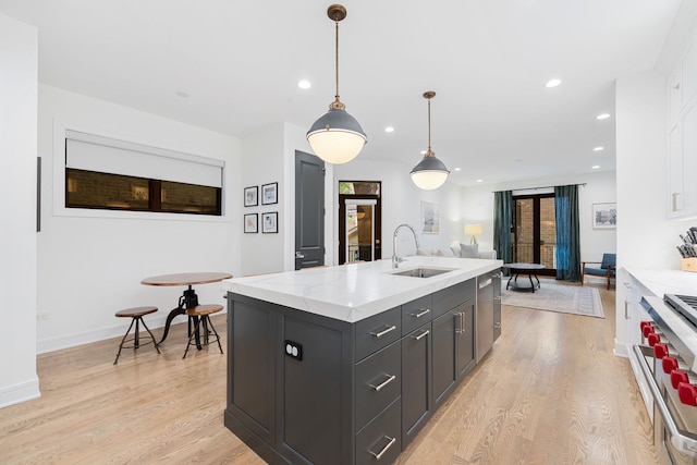 832 W Altgeld St Unit 1, Chicago, IL 60614 - kitchen with appliances with stainless steel finishes, white cabinets, light wood-type flooring, a center island with sink, and recessed lighting