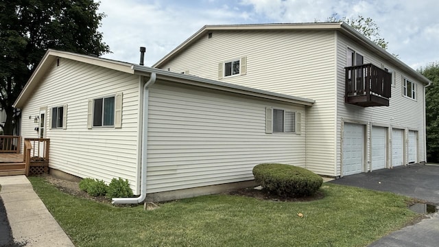 907 Gael Dr Unit D, Joliet, IL 60435 - view of property exterior with a balcony, driveway, a lawn, and a garage