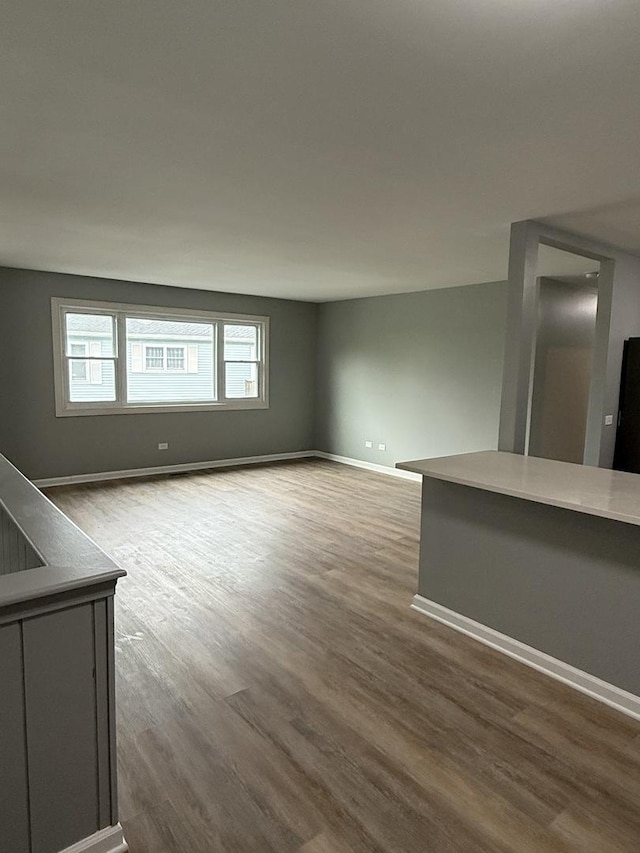 907 Gael Dr Unit D, Joliet, IL 60435 - unfurnished living room featuring wood finished floors and baseboards