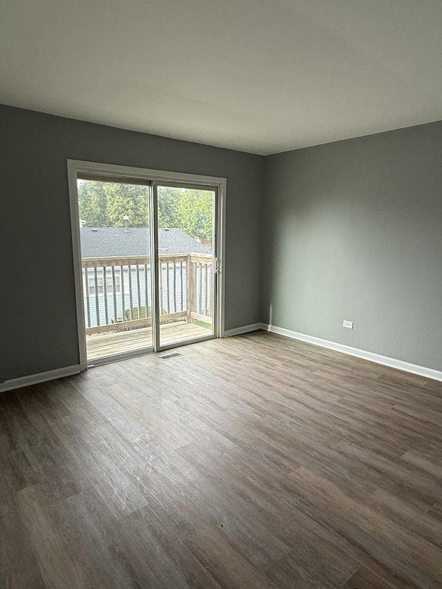 907 Gael Dr Unit D, Joliet, IL 60435 - spare room with dark wood-style floors and baseboards