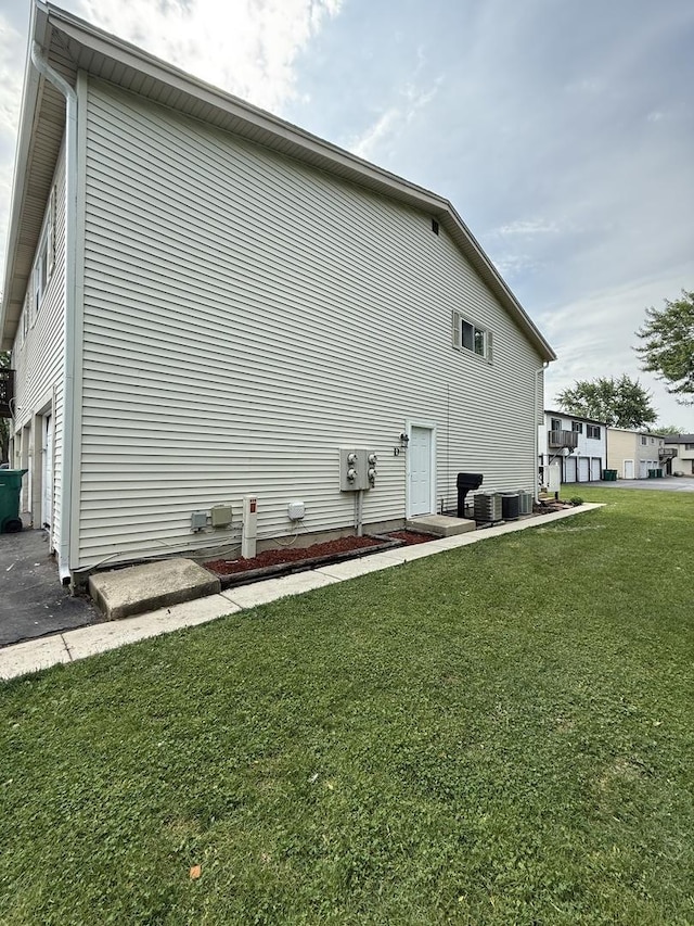 907 Gael Dr Unit D, Joliet, IL 60435 - view of property exterior with a lawn and a cooling unit
