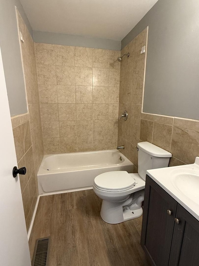 907 Gael Dr Unit D, Joliet, IL 60435 - bathroom with tile walls, wood finished floors, vanity,  shower combination, and a wainscoted wall