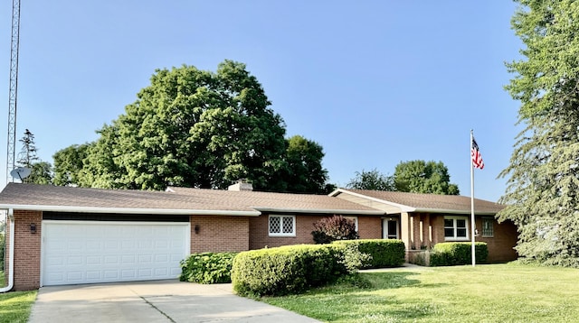 221 Thornbrook Rd, Dekalb, IL 60115 - single story home with concrete driveway, a garage, brick siding, a front lawn, and a chimney