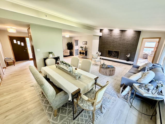 221 Thornbrook Rd, Dekalb, IL 60115 - dining room with light wood-style floors, a large fireplace, and a baseboard heating unit