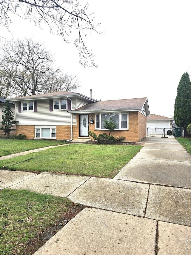 6512 Ridge Dr, Chicago Ridge, IL 60415 - split level home featuring brick siding, a front yard, and driveway
