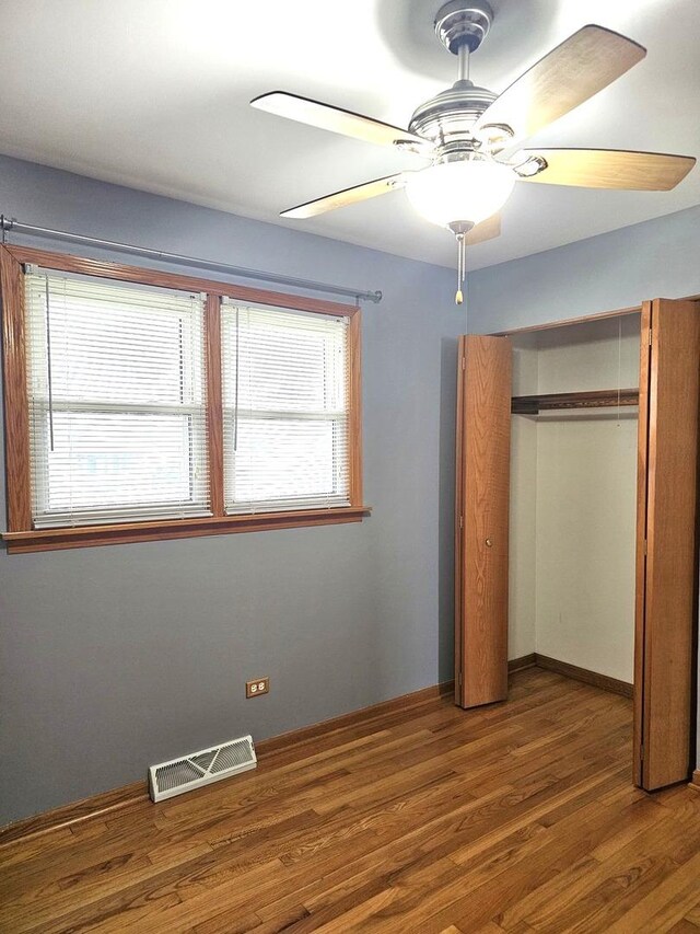 6512 Ridge Dr, Chicago Ridge, IL 60415 - unfurnished bedroom with wood finished floors, a closet, and ceiling fan