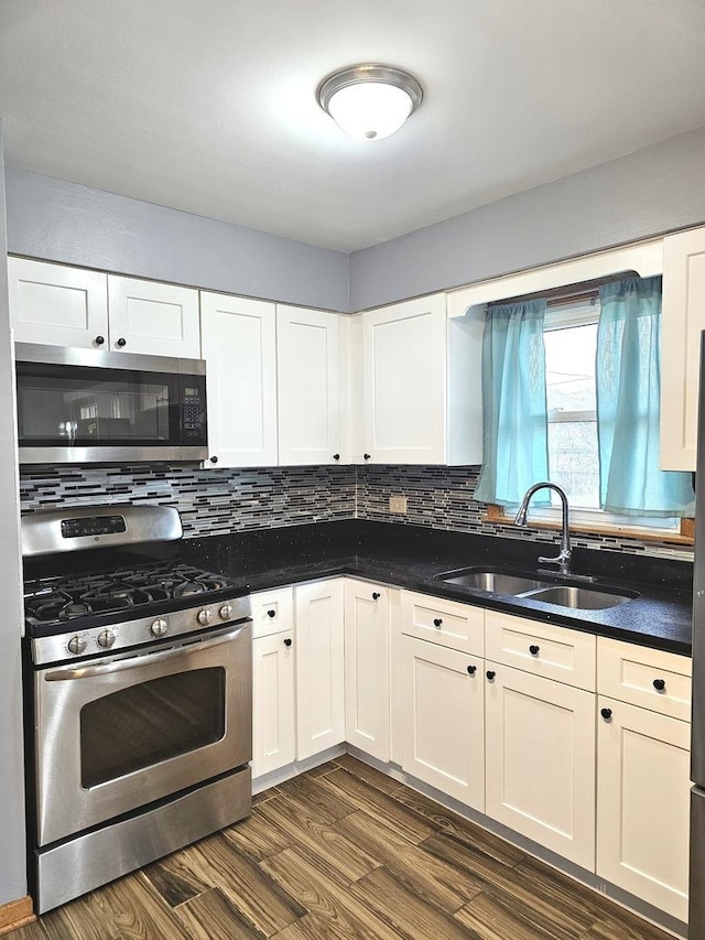 6512 Ridge Dr, Chicago Ridge, IL 60415 - kitchen featuring appliances with stainless steel finishes, dark wood-type flooring, tasteful backsplash, and white cabinetry