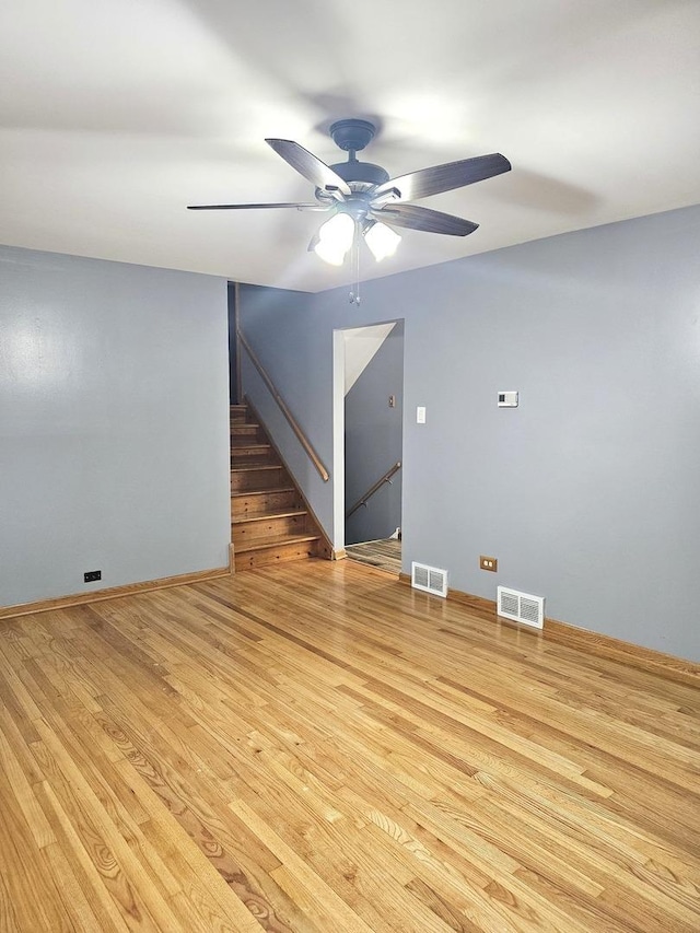 6512 Ridge Dr, Chicago Ridge, IL 60415 - unfurnished living room featuring ceiling fan, wood finished floors, and stairs