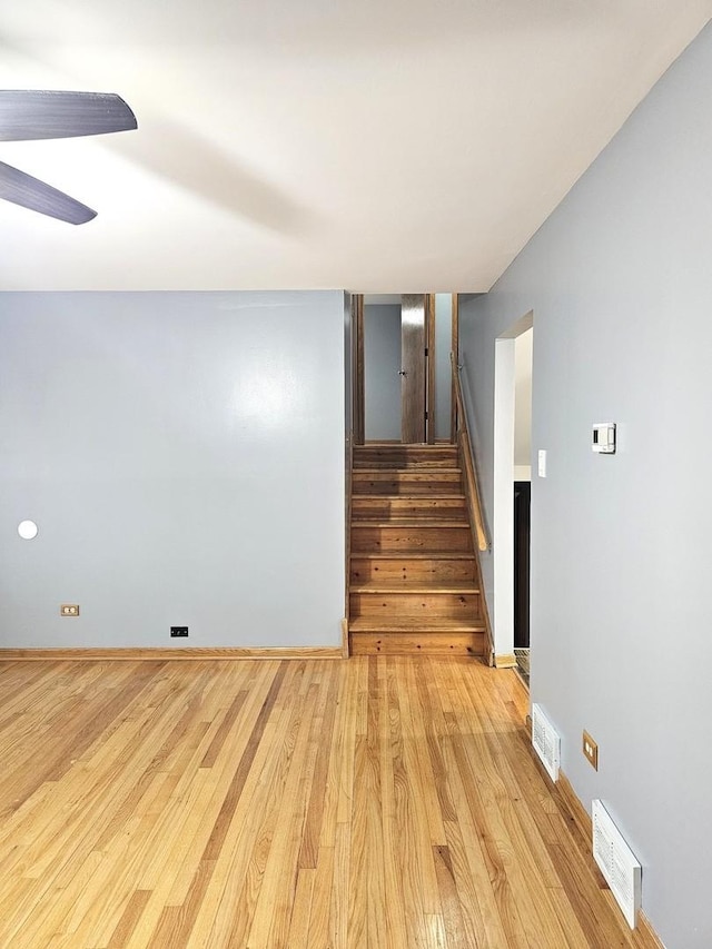 6512 Ridge Dr, Chicago Ridge, IL 60415 - empty room featuring light wood finished floors, stairway, and ceiling fan