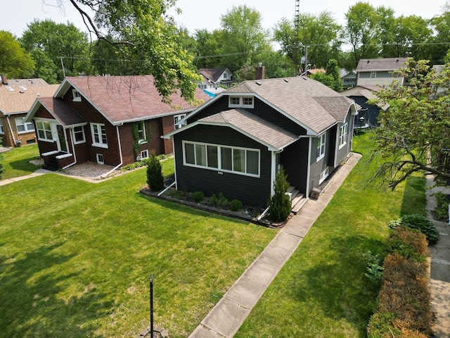 956 S Elm Ave, Kankakee, IL 60901 - view of front facade with roof with shingles, a front yard, and a chimney