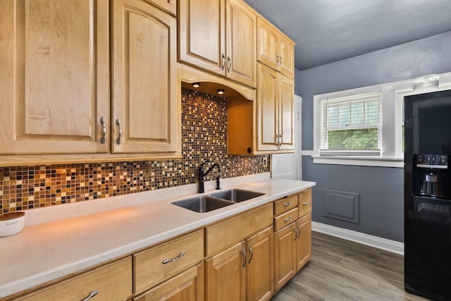 956 S Elm Ave, Kankakee, IL 60901 - kitchen with black fridge with ice dispenser, light brown cabinetry, light countertops, wood finished floors, and decorative backsplash