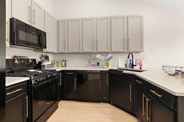 1602 Peachtree Ln, Lockport, IL 60441 - kitchen with black appliances, light countertops, a peninsula, and light wood-style floors