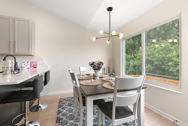 1602 Peachtree Ln, Lockport, IL 60441 - dining area featuring light wood-style floors, a chandelier, and vaulted ceiling