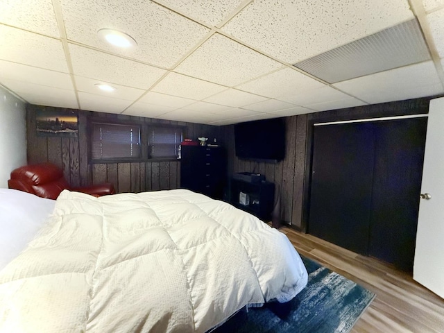 98 Northgate Rd, Riverside, IL 60546 - bedroom featuring wood finished floors, a paneled ceiling, wooden walls, and recessed lighting