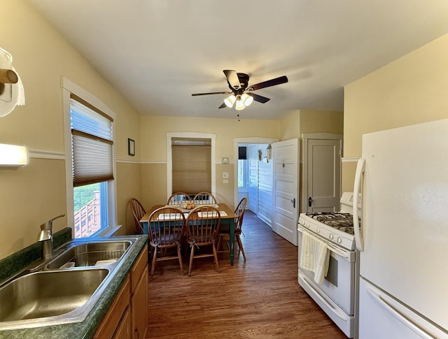 98 Northgate Rd, Riverside, IL 60546 - kitchen featuring white appliances, dark countertops, a ceiling fan, dark wood-style floors, and brown cabinets