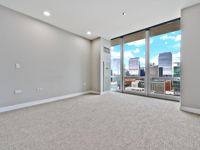 737 W Washington Blvd Unit 3003, Chicago, IL 60661 - carpeted spare room with a wall of windows, a view of skyline, and recessed lighting