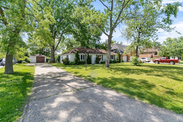 930 S Chatham Ave, Addison, IL 60101 - view of front of house featuring a front yard, a garage, and a shed