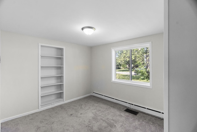 930 S Chatham Ave, Addison, IL 60101 - carpeted empty room featuring a baseboard heating unit and built in features