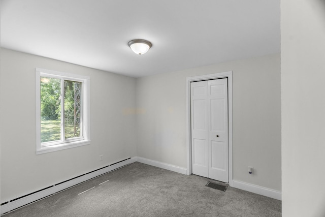 930 S Chatham Ave, Addison, IL 60101 - unfurnished bedroom featuring baseboard heating, carpet, and a closet