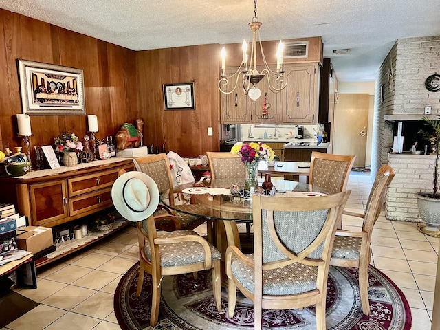 336 Flossmoor Ave, Waukegan, IL 60085 - dining area with light tile patterned flooring, a chandelier, a textured ceiling, and wood walls